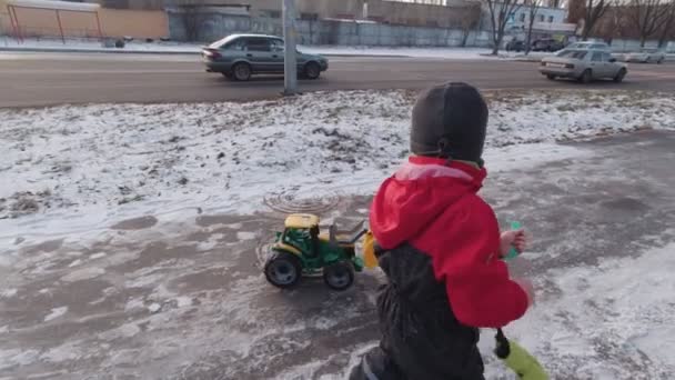 Um menino andando na rua em movimento lento de inverno — Vídeo de Stock
