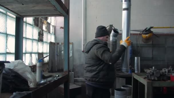Man Repairing Pipes In Workshop — Stock Video