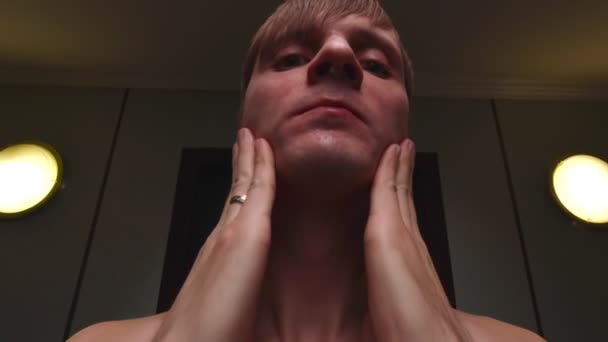 Muž aplikující krém na pomalý pohyb obličejem — Stock video