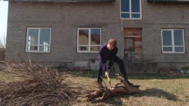 Man Cutting A Log Slow Motion
