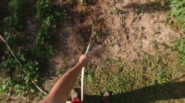 Man watering a vegetable garden POV slow motion hose water