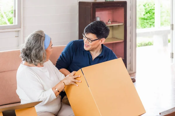 Senior asian mother and middle aged son sitting relax in living room on moving day, Happiness Asian family concepts