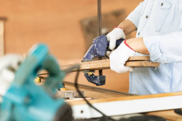 Carpenter working in wood workshop, man doing woodwork in a workshop