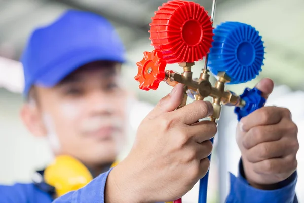 Repairman holding monitor tool to check and fixed car air conditioner system, Technician check car air conditioning system refrigerant recharge, Air Conditioning Repair