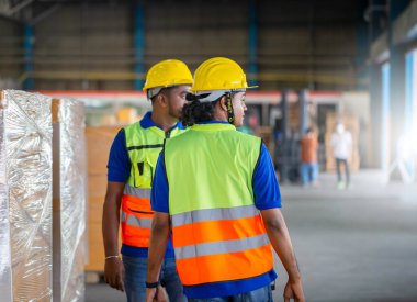 Warehouse workers working in logistics center, Workers team taking inventory in factory warehouse, Manual workers working in warehouse talking about job