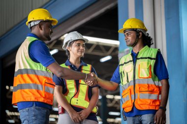 Selective focus on hands, Worker man shaking hands with his colleague at the industrial storage, Worker in uniform shaking hands with foreman at factory warehouse 