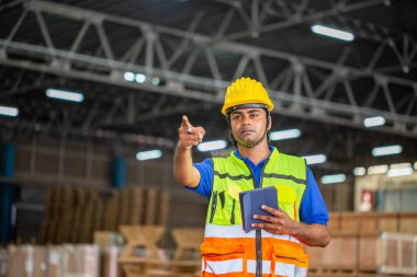 Cheerful warehouse worker with digital tablet checking inventory in warehouse, Workers working in warehouse