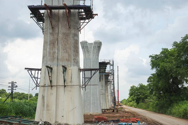 Infrastructure construct concepts, Construction of Highway line in progress with heavy infrastructure, Bridge construction site with crane lifting prefabricated concrete framework