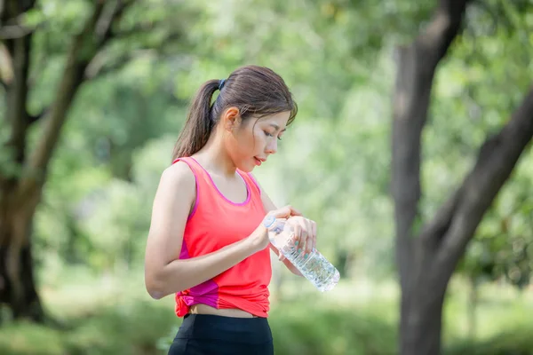 Young Beautiful Woman Plastic Water Bottle Looking Smartwatch Smartphone Sport — 图库照片