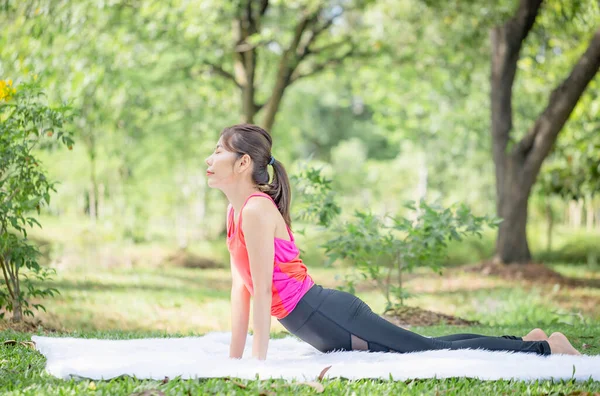 Young Woman Doing Exercises Yoga Pose Park Side View Slim — 图库照片