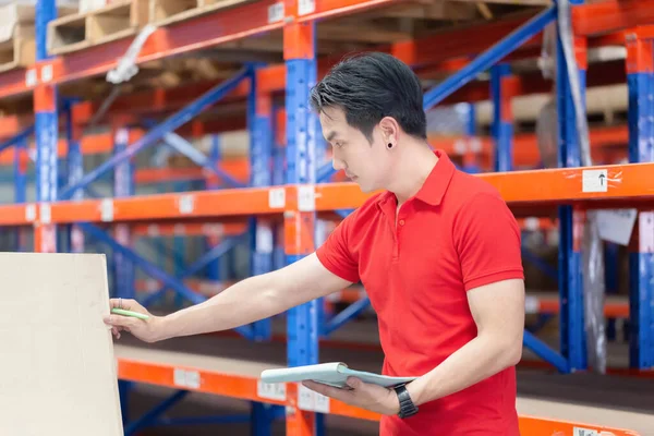 Warehouse worker checking inventory in warehouse, Forman worker working in factory warehouse