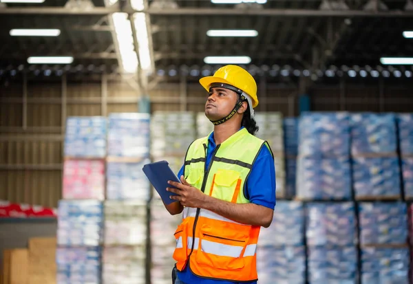 Warehouse worker with digital tablet checking inventory in warehouse, Worker man working in warehouse