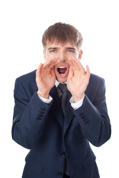 Jovem empresário gritando através de mãos isoladas no branco backg — Fotografia de Stock