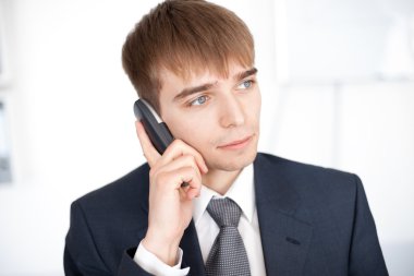 ofis cep telefonuyla konuşan genç işadamı