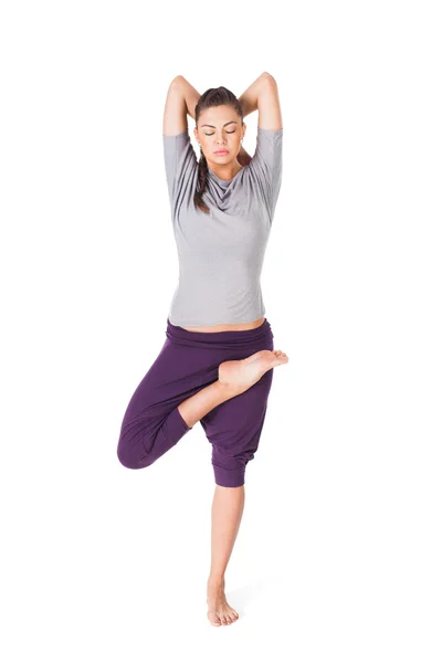 Mujer joven haciendo yoga asana árbol-pose aislado en blanco —  Fotos de Stock