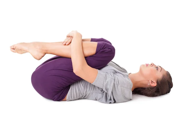 Young woman performs gymnastic exercise isolated on white — Stock Photo, Image