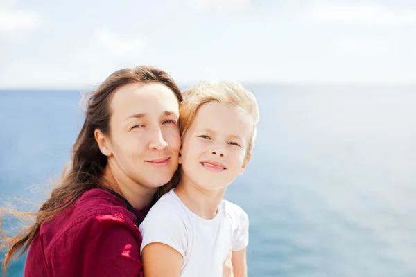 Mother and daughter on sea background — Stock Photo, Image