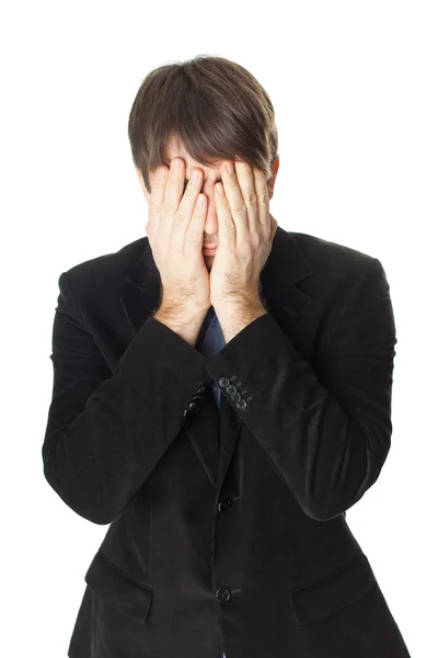 Young businessman covering his face with his hands isolated on w — Stock Photo, Image