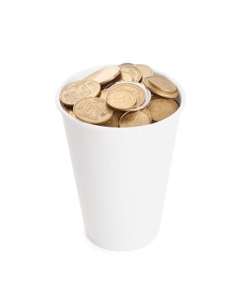 Coins in a white cup isolated on white — Zdjęcie stockowe