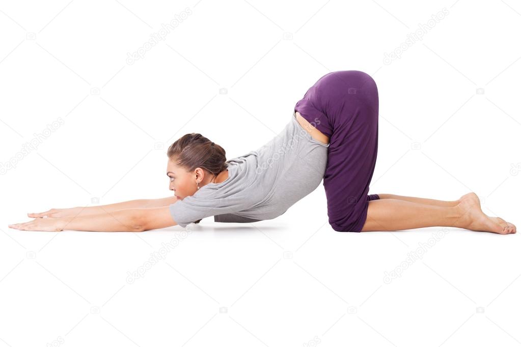 Young woman doing yoga exercise Uttana shishosana (extended pupp