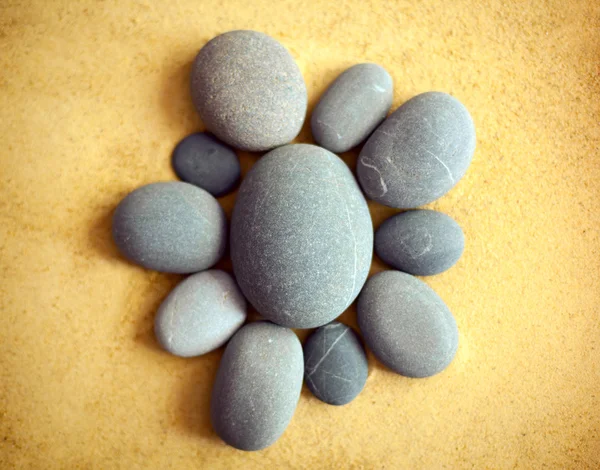 Pebble stones on sand — Stock Photo, Image