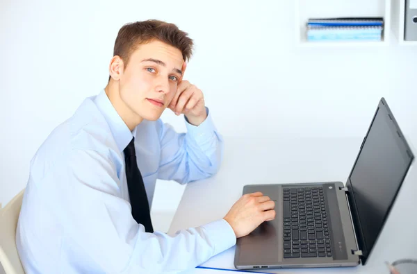Junger lächelnder Geschäftsmann arbeitet am Laptop — Stockfoto