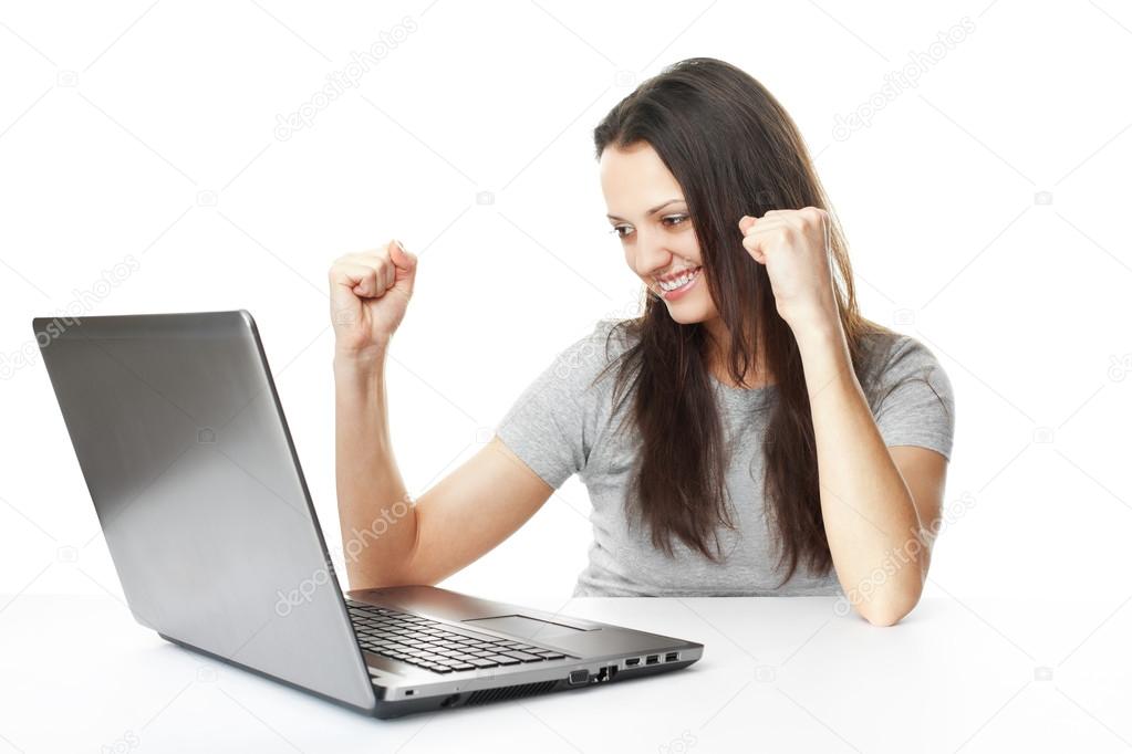 Young woman having success online on her laptop