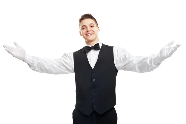 Unga leende servitör öppnar famnen i Välkommen — Stockfoto