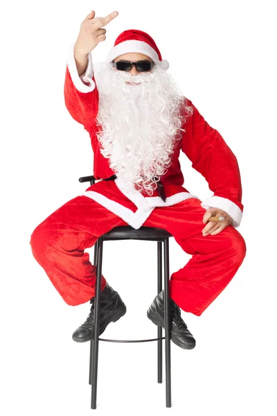 Santa Claus showing the middle finger sitting in a chai — Stock Photo, Image