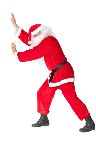 Weihnachtsmann schiebt etwas an — Stockfoto