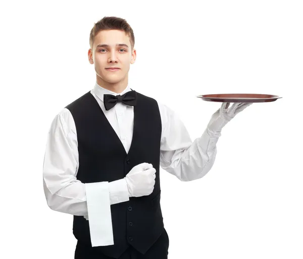 Joven camarero sonriente con bandeja vacía — Foto de Stock