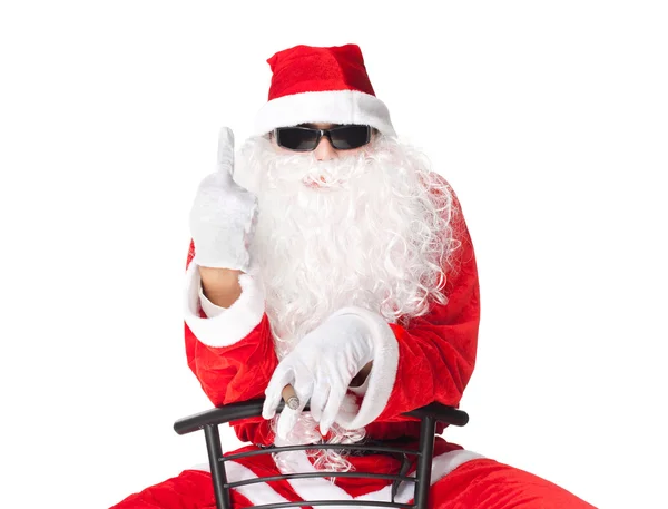 Santa Claus showing the middle finger sitting in a chai — Stock Photo, Image