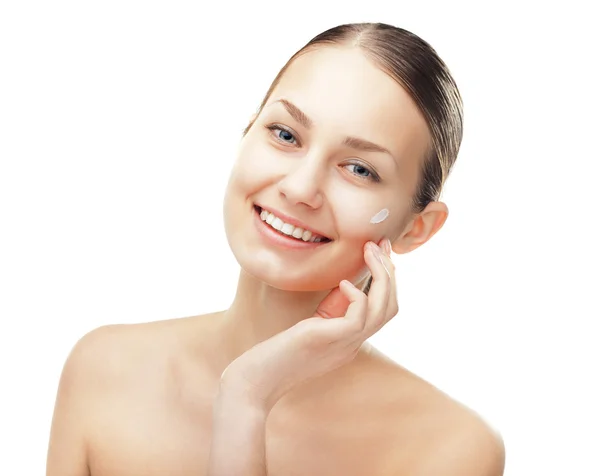 Young woman with cosmetic cream on a cheek — Stock Photo, Image