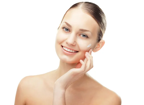 Young woman with cosmetic cream on a cheek — Stock Photo, Image