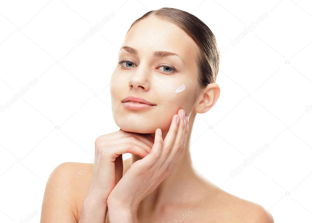 Young woman with cosmetic cream on a cheek