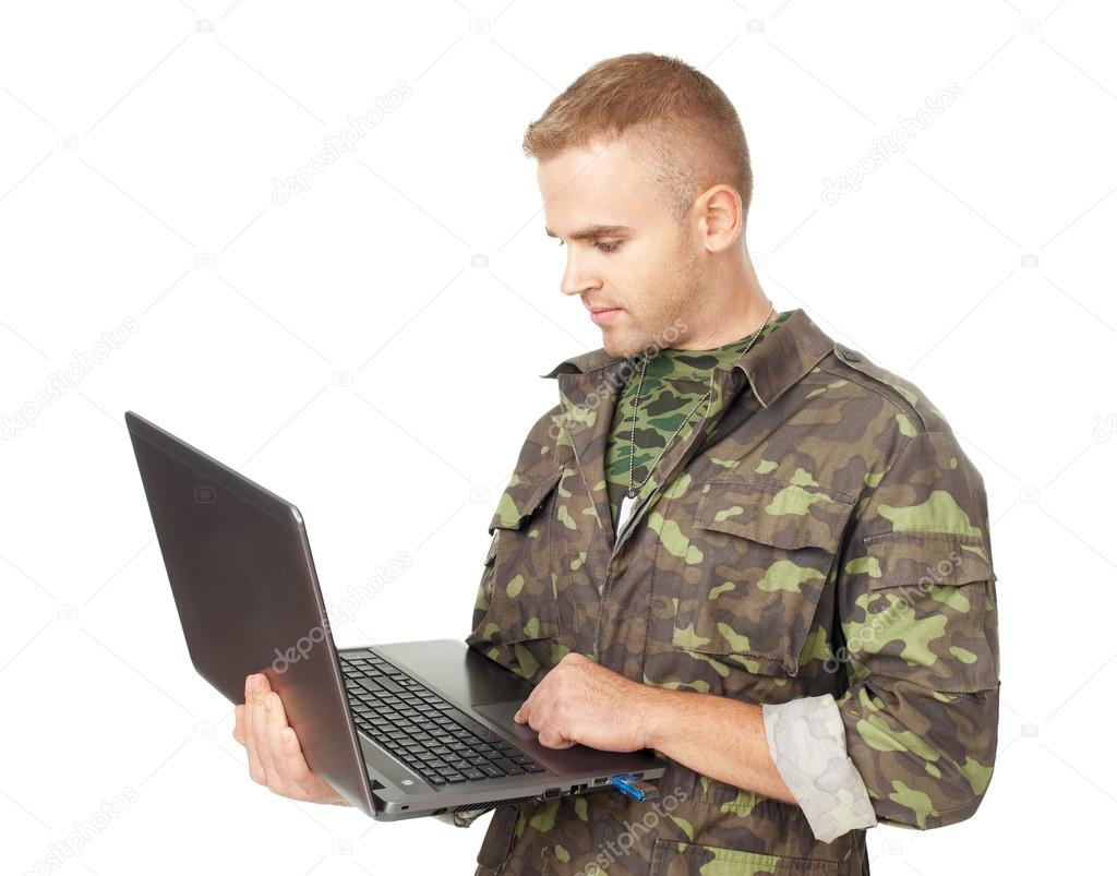 Young army soldier with a laptop