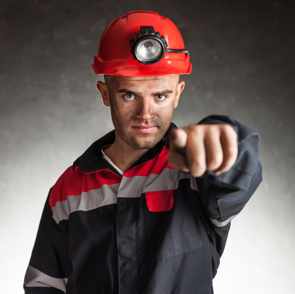 Coal miner pointing forward