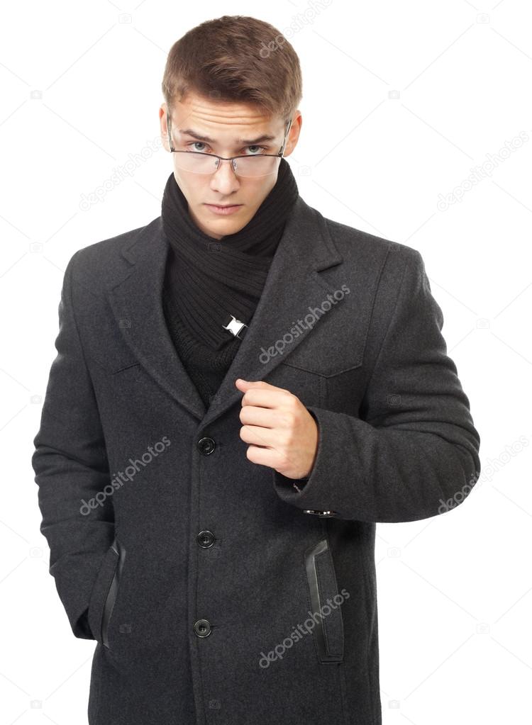 Young man looking over glasses