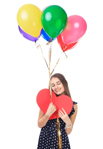 Happy woman with balloons hugging heart — Stock Photo, Image