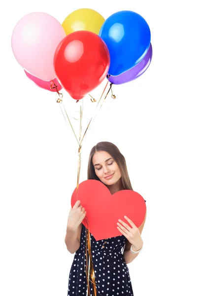 Mujer feliz con globos abrazando el corazón — Foto de Stock