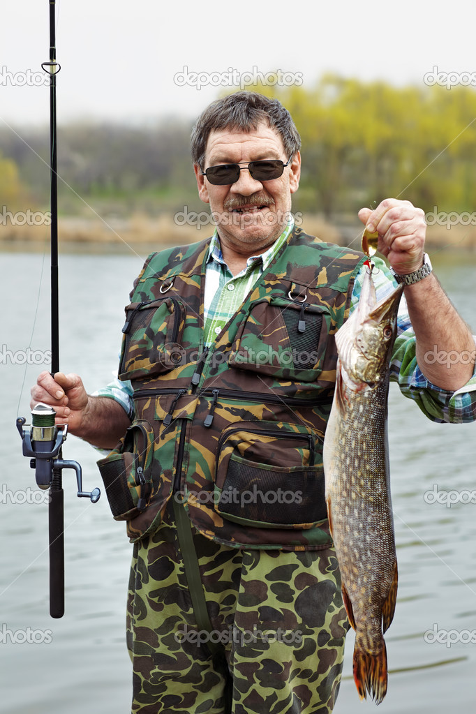 Mature fisherman with his catch