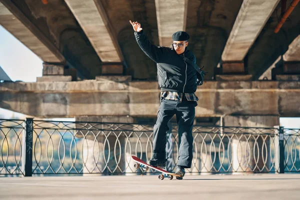 Skateboarder does ollie trick on street urban background — Foto Stock