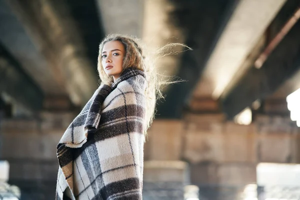 Ritratto di donna piuttosto fiduciosa avvolto in coperta di lana cercando di fotocamera posa su sfondo urbano strada con spazio copia — Foto Stock