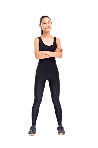 Full längd porträtt av sportig kvinna med korsade händer — Stockfoto