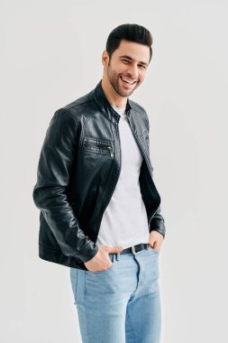 Portrait of happy smiling man posing on studio white background