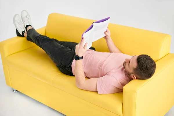 Der Mann Entspannt Sich Auf Dem Sofa Und Liest Buch — Stockfoto