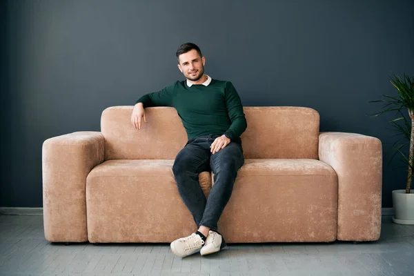 Handsome Trendy Man Posing Looking Camera While Sitting Comfort Sofa — Stok fotoğraf