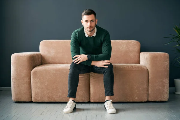 Handsome Trendy Man Posing Looking Camera While Sitting Comfort Sofa — Zdjęcie stockowe