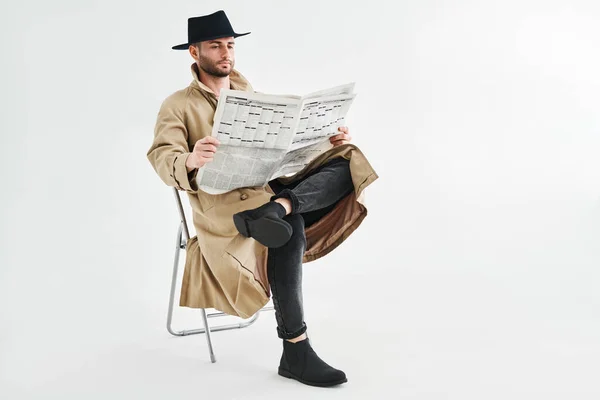Young Handsome Man Trench Coat Hat Reading Newspaper Sitting Chair — Fotografia de Stock