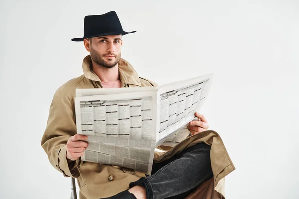 Young Handsome Man Trench Coat Hat Reading Newspaper Sitting Chair — 스톡 사진